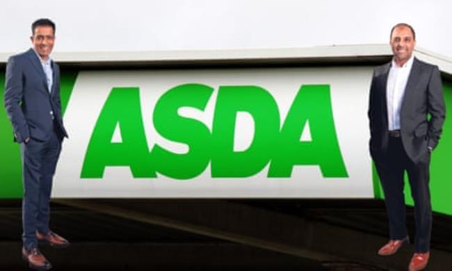 Billio<em></em>naire brothers Mohsin and Zuber Issa pose next to an Asda sign